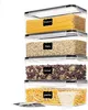 A stack of clear plastic food storage containers filled with different food items, such as spaghetti, oats, cereal, and pasta. Each container has a black label with white text indicating its contents. Produktbild-Vorschau