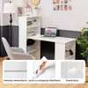 A white desk with a bookshelf attached, a laptop, and a chair in a room with patterned wallpaper. Podgląd zdjęcia produktu