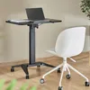 A mobile laptop desk with a laptop and tablet on it, next to a white office chair. Náhled obrázku produktu