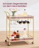 A gold-colored bar cart with purple glass shelves, holding bottles of alcohol, glasses, and a vase of flowers. Produktbild-Vorschau
