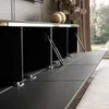 A modern black TV cabinet with its doors open, revealing internal compartments and hydraulic hinges. The cabinet has a subtle gold trim and is illuminated by integrated LED lighting. Produktbild-Vorschau