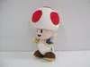 A plush toy of the character Toad from Nintendo's Super Mario franchise is shown standing against a plain background. Anteprima dell’immagine prodotto