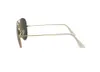 A side view of a pair of gold-rimmed aviator sunglasses with green lenses, isolated on a white background. Náhled obrázku produktu