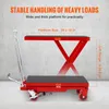 A red hydraulic scissor lift table is shown against a concrete wall background, with text overlays highlighting its features and dimensions. Voir les images du produit