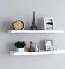 Two white shelves mounted on a light gray wall, decorated with various items. Voir les images du produit