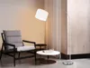 A modern living room scene with a chair, coffee table, and a floor lamp. Náhled obrázku produktu