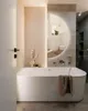 A modern bathroom with a freestanding bathtub and a large, illuminated circular mirror. Produktbild-Vorschau