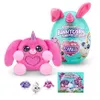 A pink plush bunnycorn toy and its teal egg-shaped packaging are displayed on a white background, along with smaller surprise toys and a product box. Anteprima dell’immagine prodotto