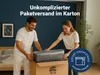 A couple is packing a mattress into a box for shipping. Produktbild-Vorschau
