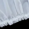 A close-up view of the bottom edge of a white sheer curtain with ruffles and a satin band. Produktbild-Vorschau