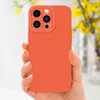 A hand holding an orange phone case with a floral background. Produktbild-Vorschau