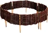 A circular garden border made of woven willow branches, supported by wooden stakes. Produktbild-Vorschau