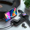 A Satechi Quatro Wireless Power Bank is shown charging an iPhone, an Apple Watch, and AirPods, along with a set of keys and a backpack in the background. Produktbild-Vorschau