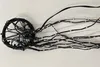 A close-up, overhead view of a black LED string light set with multiple strands extending from a circular base. Produktbild-Vorschau