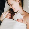 A mother holding her newborn twins. Produktbild-Vorschau