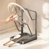 A hand is placing a pot lid on a kitchen organizer stand. Produktbild-Vorschau