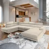 A spacious, modern living room with a large sectional sofa, kitchen area, and dining area visible in the background.