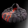 A dark, textured cake shaped like a volcano with red 'lava' flowing from a cracked sphere on top. Anteprima dell’immagine prodotto