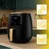 A black and gold air fryer is displayed on a kitchen counter, with stylized icons of food items on the right. Produktbild-Vorschau