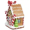 A festive gingerbread house ornament with candy cane decorations and a small Christmas tree. Produktbild-Vorschau