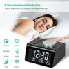 A woman sleeping in bed next to a digital alarm clock. Produktbild-Vorschau
