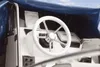 The interior of a boat's cockpit with a steering wheel and navigation equipment. Podgląd zdjęcia produktu