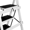 A close-up view of a white step stool with black treads. Voir les images du produit