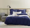 A bedroom scene with a neatly made bed and a chair. Produktbild-Vorschau
