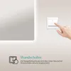 A hand is shown pressing a wall switch next to a mirror with integrated lighting. Náhled obrázku produktu