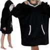 A person wearing a black oversized hoodie with a light gray lining. Náhled obrázku produktu