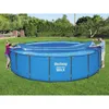 A man and a woman are putting a cover on a large blue above-ground swimming pool in a grassy backyard. Náhled obrázku produktu