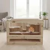 A hamster cage with multiple levels, placed indoors on a wooden floor, with a window and furniture in the background. Anteprima dell’immagine prodotto