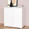 A white cabinet with two doors is shown in a room with a light pink wall and a wooden floor. Produktbild-Vorschau