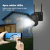 A security camera is mounted on a wall, with a smartphone displaying a live feed of a house in the foreground. Podgląd zdjęcia produktu