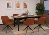 A dining room set with chairs and a table, decorated with artwork on the wall and a plant. Náhľad obrázku produktu