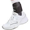 A close-up shot of a white athletic shoe with a black ankle brace on the wearer's foot. Produktbild-Vorschau