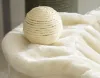 A close-up of a sisal ball on a soft, fluffy surface. Produktbild-Vorschau