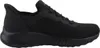A side view of a black Skechers slip-on sneaker. Voir les images du produit
