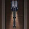 A close-up shot of the nozzle and dustbin of a handheld vacuum cleaner against a wooden background. Náhled obrázku produktu