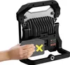 A hand is inserting a battery into a portable LED work light. Produktbild-Vorschau