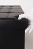 A gloved hand is shown lifting the lid of a black storage ottoman. Náhľad obrázku produktu