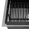 Close-up view of a sink rack with metal rods and black rubber grips, placed inside a stainless steel sink. Podgląd zdjęcia produktu