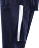 Close-up of the lower leg of navy blue training pants with a white stripe and a zippered vent. Voir les images du produit