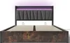 A modern bed frame with a padded headboard featuring LED lighting. Voir les images du produit