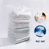 A stack of vacuum-sealed bags filled with bedding, with inset images showing how to use the vacuum bags and a vacuum pump. Produktbild-Vorschau