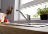 A kitchen sink with a faucet and a plant on the windowsill. Produktbild-Vorschau