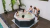 A family enjoys a hot tub on a wooden deck. Náhľad obrázku produktu