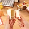Hands assembling a miniature dollhouse kitchen cabinet. Náhľad obrázku produktu