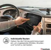 A person's hands are shown interacting with a TomTom navigation device mounted in a truck cab. Produktbild-Vorschau
