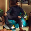 A man is sitting on a bean bag chair in a modern indoor setting. Náhľad obrázku produktu
